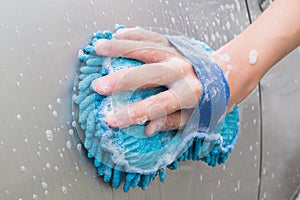 Hand washing Brown Car with blue sponge and bubbles Foam