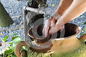 Hand washing in the clay pot sink