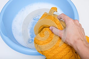 Hand washing of delicate woolen knitted clothes, sweaters concept