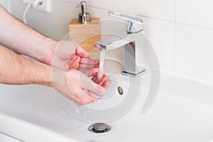 Hand washing with soap in bathroom to prevent contaminate, close up