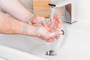 Hand washing with soap in bathroom to prevent contaminate, close up