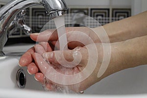 Hand washing. Wash hands under running water