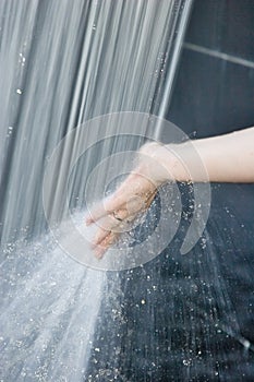 Hand in the water spray