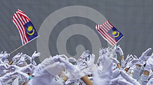 Hand waving Malaysia flag also known as Jalur Gemilang