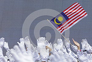 Hand waving Malaysia flag also known as Jalur Gemilang