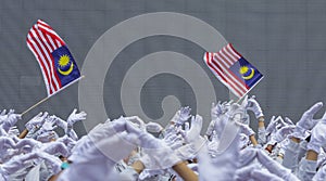 Hand waving Malaysia flag also known as Jalur Gemilang photo