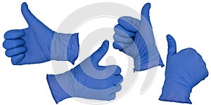 Hand wearing blue nitrile examination glove makes a thumbs up gesture