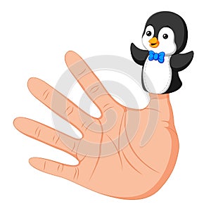 Hand wearing a cute penguin finger puppet on thumb