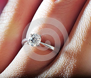 Hand wearing diamond ring