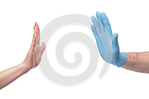 Hand wearing gloves stops hand without gloves