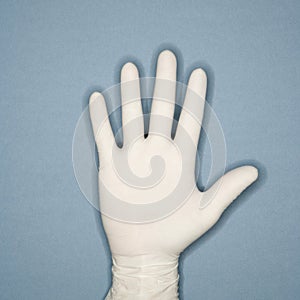 Hand wearing latex glove. photo