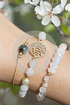 Hand wearing popular gemstone mineral bead yoga bracelets