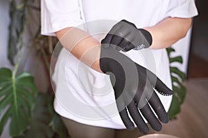 The hand wearing a rubber glove. Symbolizing safety in work. It conveys approval