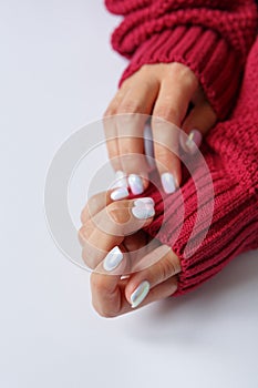 Hand on a white background and beautiful pearl manicure close up