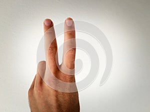 Hand on a white background, part of the body, part of the hand, white skin, two fingers, sho