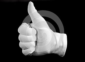 Hand in a white cotton glove gesturing a thumbs up