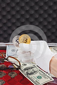 Hand in the white glove with gold and silver coins