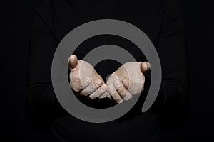 Hand of white man open hand for holding object other mean is helping giving or beg concept on black background dark style