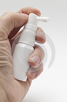 Hand with white spray bottle