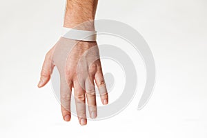 Hand with white wristband mockup. Empty ticket wrist band design