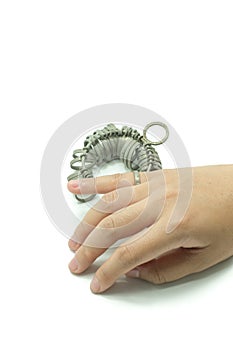 Hand wiith Jeweler finger sizing tools isolated