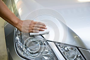 Hand with a wipe the car polishing