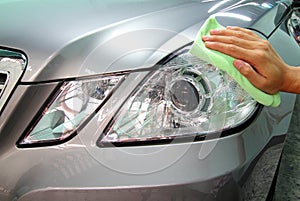 Hand with a wipe microfiber the car polishing