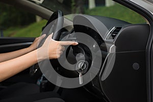 Hand woamn driver using turn signal control light in car