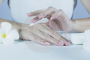 Hand of woman apply lotion on skin of back hand