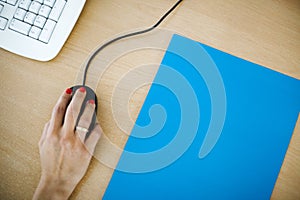 Hand of a woman on a black mouse