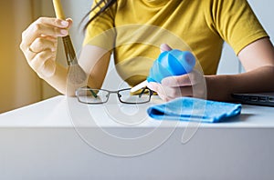 Hand woman cleaning her glasses with cloth,Clean lenses of eyeglasse