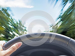 Hand of woman driving car