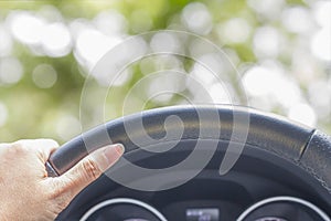 Hand of woman driving car