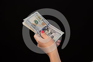 Hand of woman giving money. United States Dollars or USD. Hand holding Banknotes. Hands holding a 100 bill