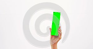 Hand of a woman holding green pla card