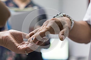 Hand of a woman holding the hand of a man