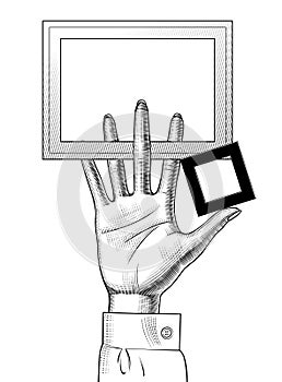 Hand of woman holding a rectangular frames in fingers