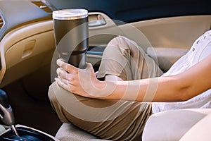 Hand woman holding reusable drink a cup in car,Environmental friendly,Healthy green,Zero waste,Conscious lifestyle concept