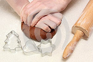Hand of woman kneading dough for Christmas cookies