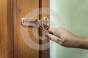 hand of woman locked hoop chain for safety