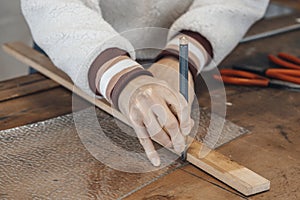 hand of woman master glassmaker at work in a workshop