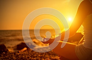 Hand of woman meditating in a yoga on beach