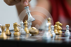 Hand of woman playing chess for business tactic and planning metaphor select focus shallow depth of field