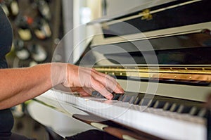 Hand of a woman playing the piano