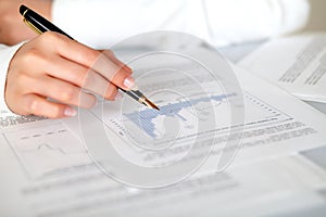 Hand of a woman pointing a graph