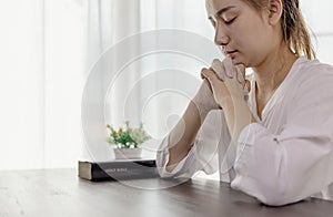 Hand of woman while praying for christian religion, Casual woman praying with a cross, Religion concept