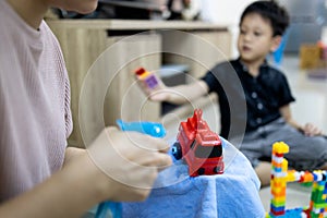 Hand of woman is spraying alcohol antiseptic,disinfecting toys,cleaning toys at home,disinfection,health care during a pandemic of photo