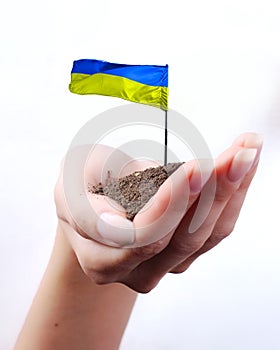 Hand of woman and Ukrainian flag at white background