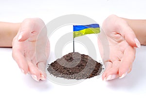 Hand of woman and Ukrainian flag at white background