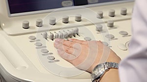 Hand of woman and ultrasound examination medical equipment.